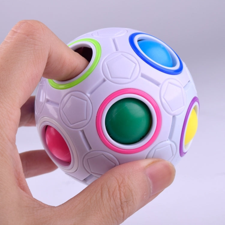 White magic ball puzzle cube with colorful circular buttons and openings