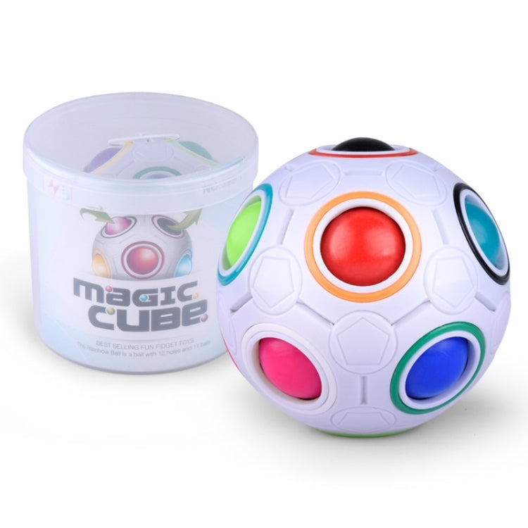 White magic ball puzzle cube with rainbow ringed face details beside jar