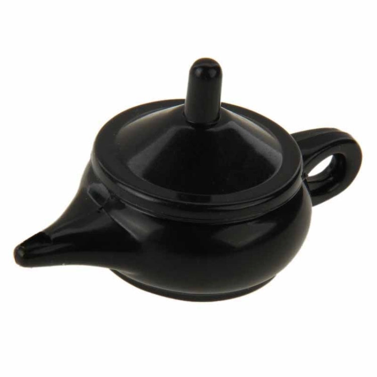 Black teapot magic prop with round lid, spout handle, and coin insert