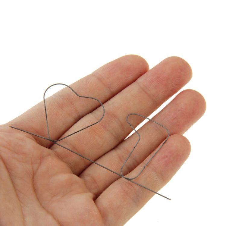 Memory metal wire laid across open palm, slender dark metal prediction prop