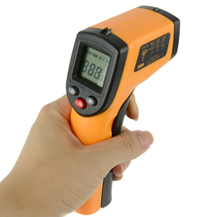 Orange infrared thermometer held in hand, LCD screen and red power indicator