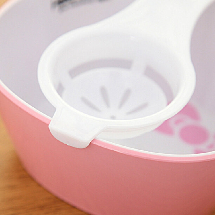 Egg yolk separator, white scoop-style holder in a bowl
