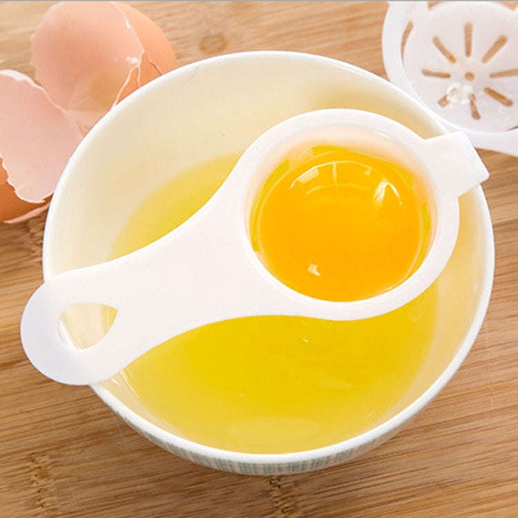 Egg yolk separator insert in white scoop bowl, bright yellow yolk