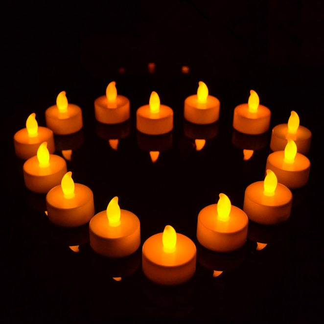 Orange flameless LED tea light candles arranged in a ring, multiple glowing flames