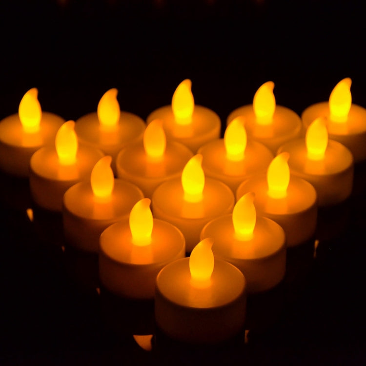 Orange flameless LED tea light candles grouped together, glowing flame effect