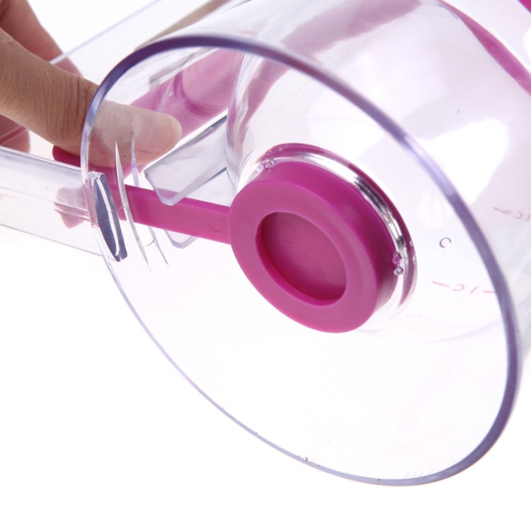 Close-up of clear batter dispenser cup tilting with pink bottom spout and handle