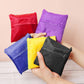 Assorted foldable nylon grocery pouches in red, purple, yellow, blue, and black