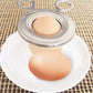Boiled egg shell cutter tool placed over a hard-boiled egg on a plate
