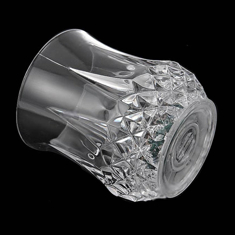 Clear faceted LED light cup close-up, reflective diamond facets on curved sides