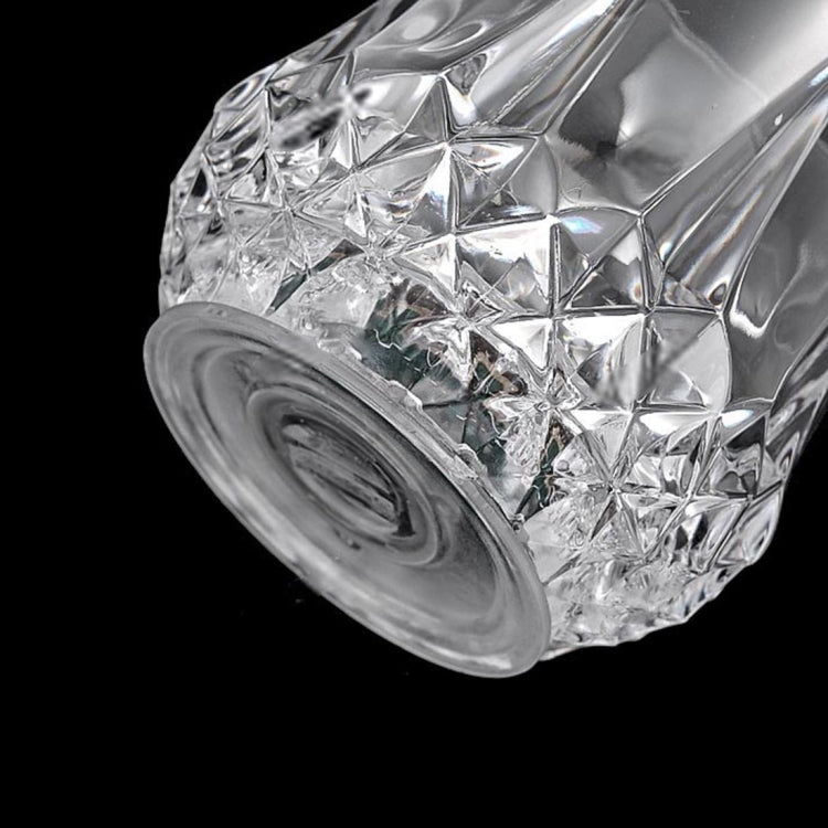 Clear faceted LED light cup with textured base, view of underside details