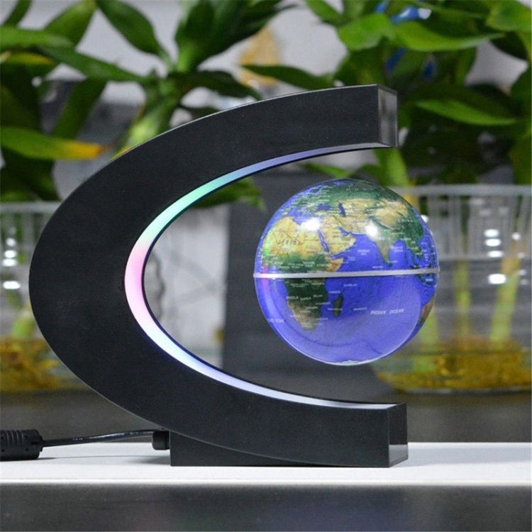 Black magnetic floating globe with glowing multicolor LED ring on stand