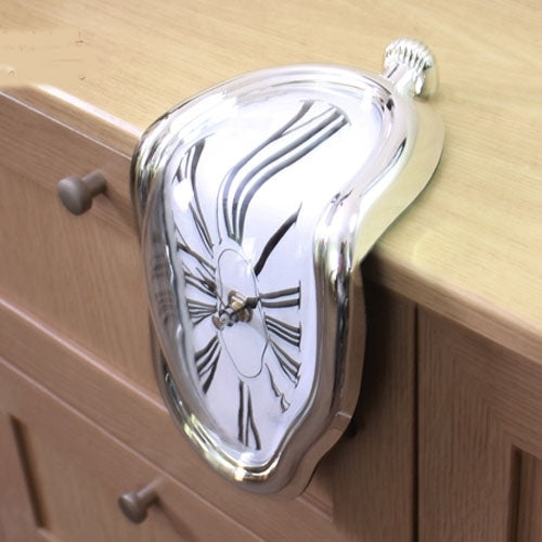 Warped chrome novelty clock mounted on wooden furniture with roman numeral face