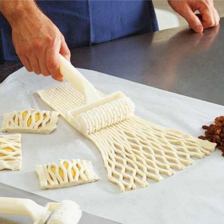 White plastic noodle netting cutter rolling lattice on dough sheet