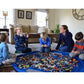 Round blue kids toy storage bag spread on a living room floor for play