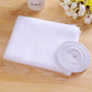 White fly screen mesh sheet and rolled hook-and-loop strip on wooden surface