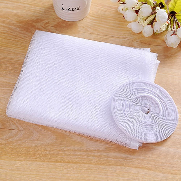 White fly screen mesh sheet and rolled hook-and-loop strip on wooden surface