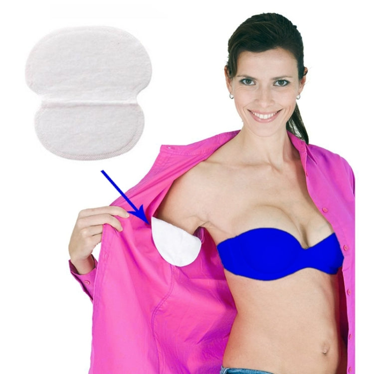 Underarm sweat pad with curved adhesive backing, white, shown being attached to clothing
