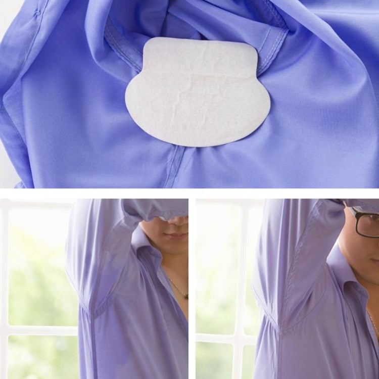 White underarm sweat pad stuck to fabric, oval shape with textured adhesive edge