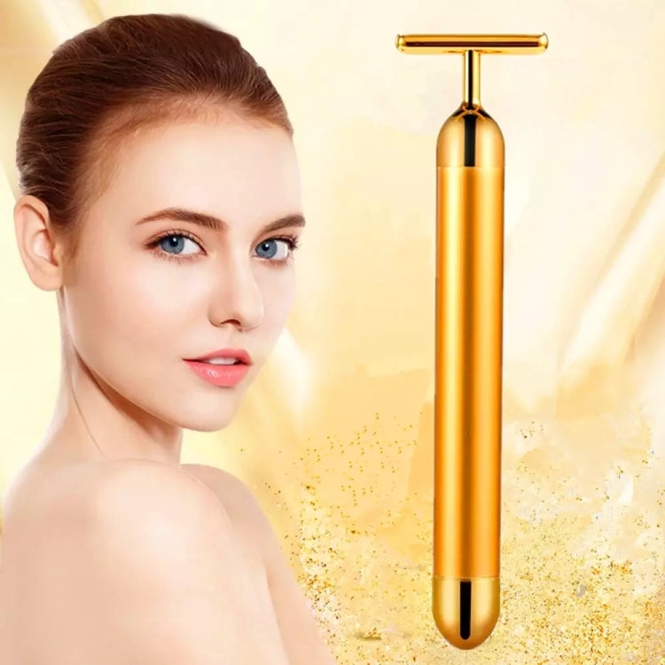 Gold electric face massage stick with T-bar head and smooth cylindrical handle.