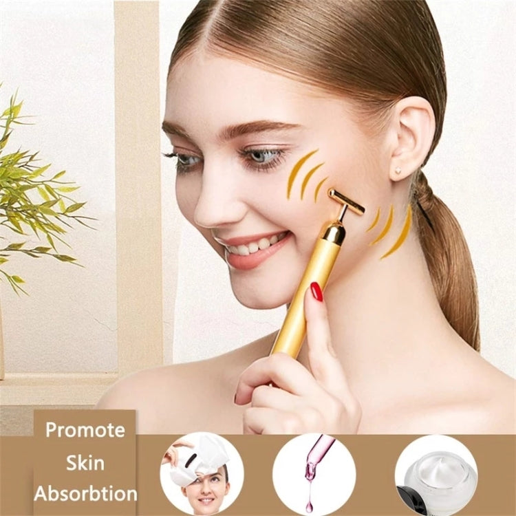 Gold electric face massager stick with U-roller head used along the jawline