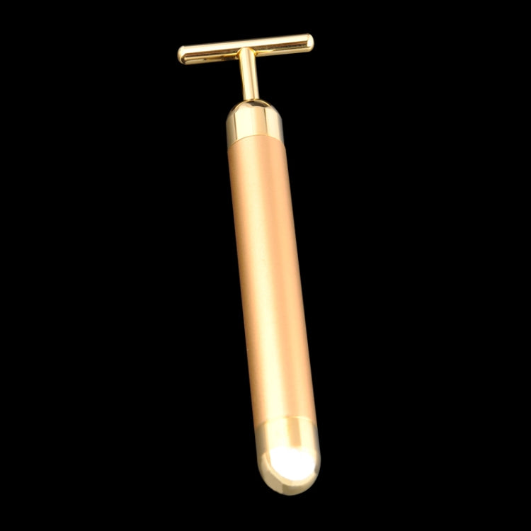 Gold electric face massager stick with T-bar head, angled view and rounded base.
