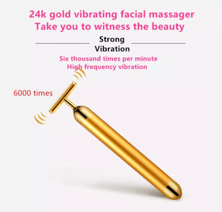 Gold vibrating face massage stick with T-bar head and smooth cylindrical handle.