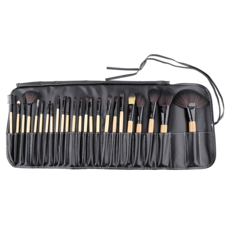 Open black brush roll showing multiple bristle brushes with wooden handles and bag strap