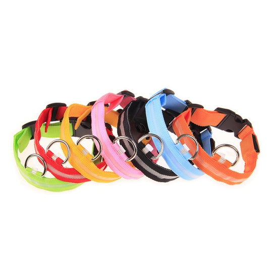 Stack of adjustable LED flashing dog collars with metal D-rings in assorted colors