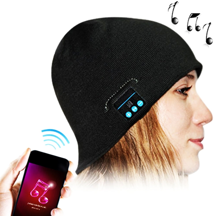 Black knit beanie on wearer with Bluetooth control module visible near temple