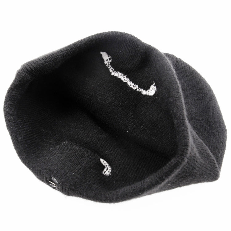 Black knit beanie with visible inner seam and stitched interior details