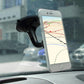 Black car phone mount holder with suction base securing a smartphone on the dash