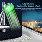 Chrome shower head with green illuminated water stream