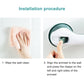 Suction safety handle in white with dark green pads, shown during wall mounting