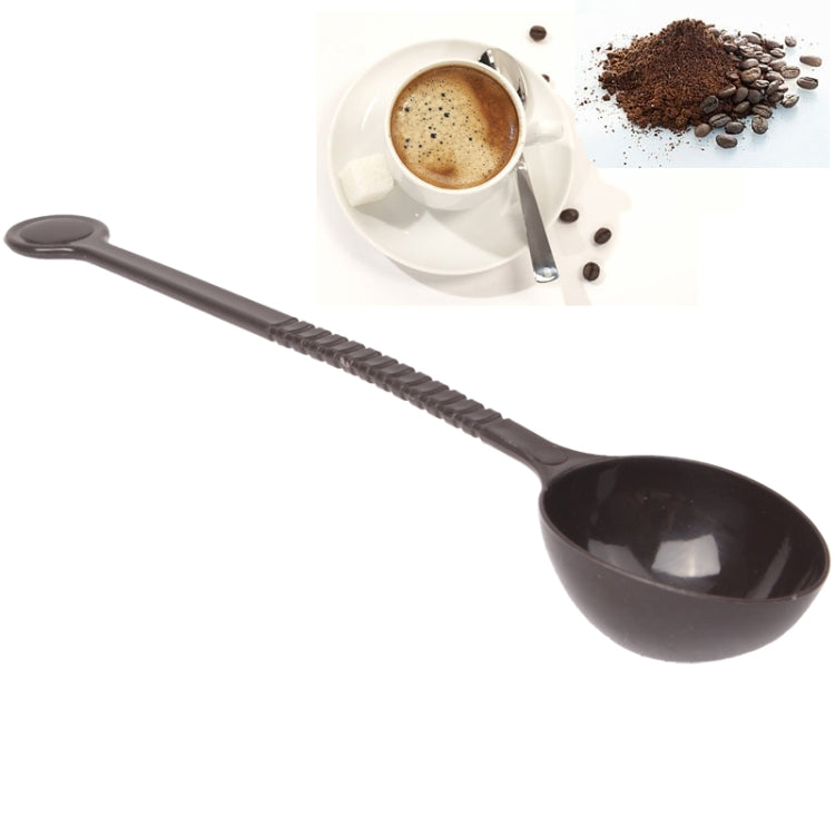 Dark plastic coffee measuring spoon with ridged handle and oval bowl