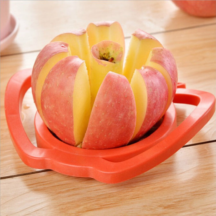 Red apple separator device holding sliced apples, quartered around a center core