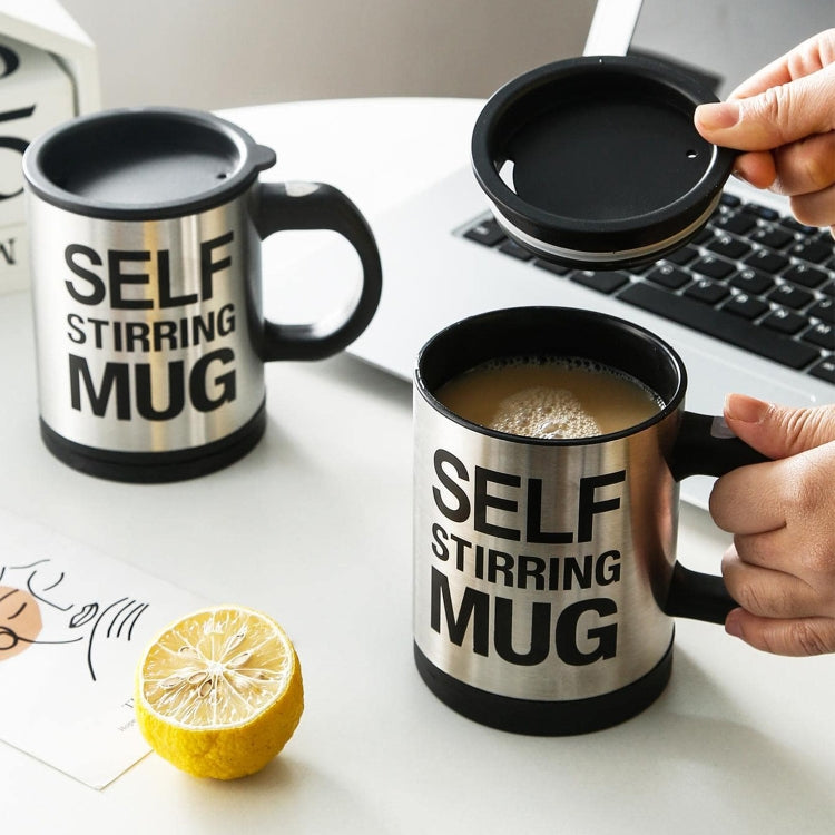 Two self-stirring mugs on a table, each with black lid and “SELF STIRRING MUG” text