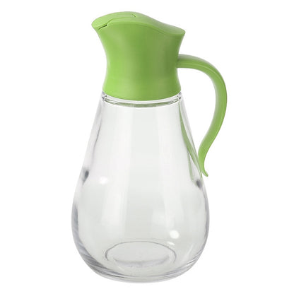 Green-topped glass oil bottle with pour handle and automatic push-lid spout