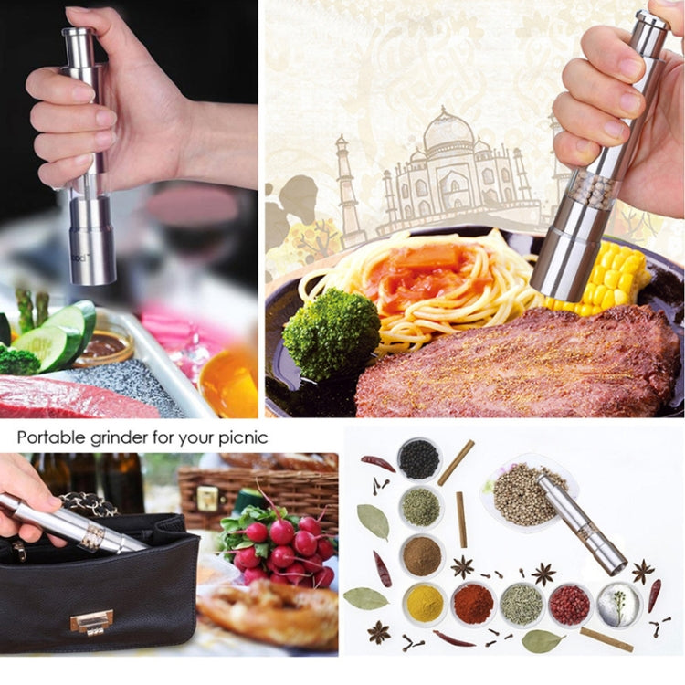 Stainless steel salt and pepper grinder mill shown in use by hand