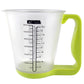 Clear measuring cup with printed scale and green digital handle