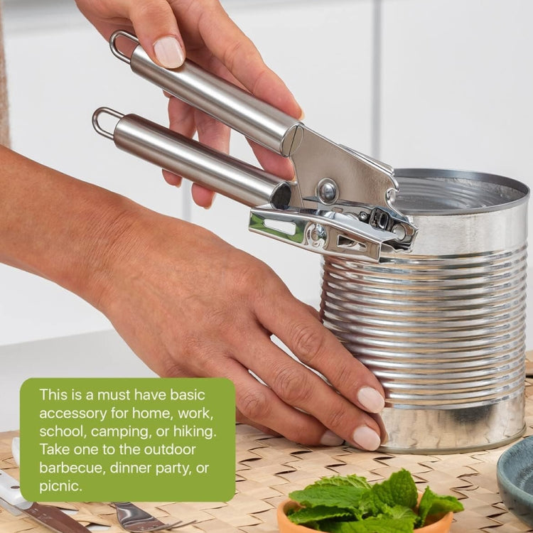Stainless steel can opener in use on metal can, handheld spring lever, silver