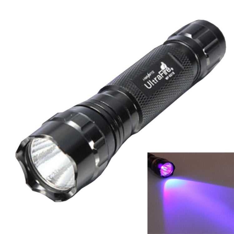 Black UV flashlight with textured grip, illuminated purple light beam