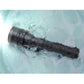 Black LED diving flashlight submerged in water with droplets on the body.