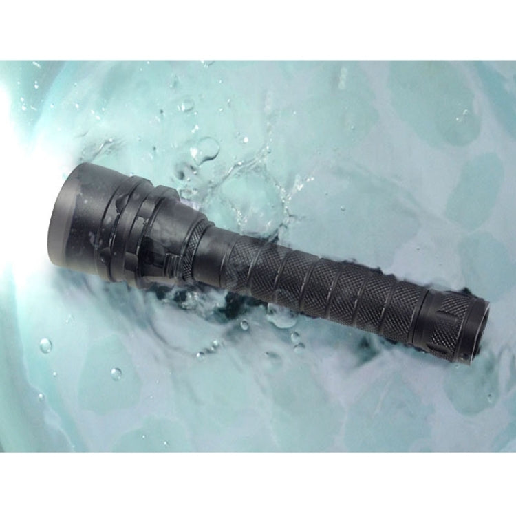 Black LED diving flashlight submerged in water with droplets on the body.