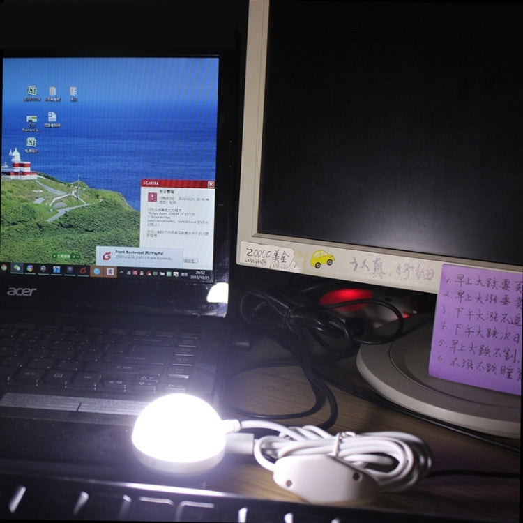 USB LED mini bulb light lit on a desk with USB cable