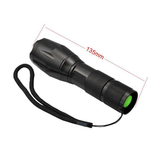 Black LED flashlight with lanyard strap, textured grip, and green tail cap; 135mm
