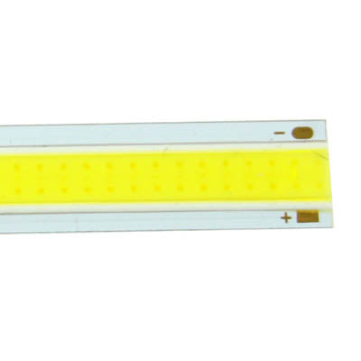 Close-up of yellow LED strip in white housing with visible contact ends