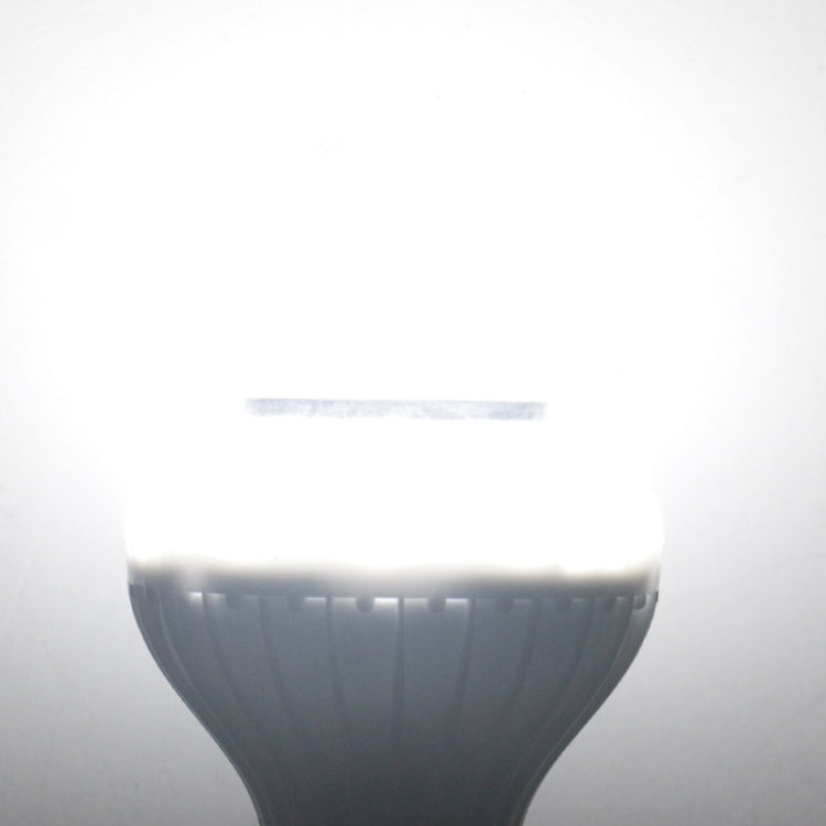 White smart LED bulb emitting bright light, lamp top centered