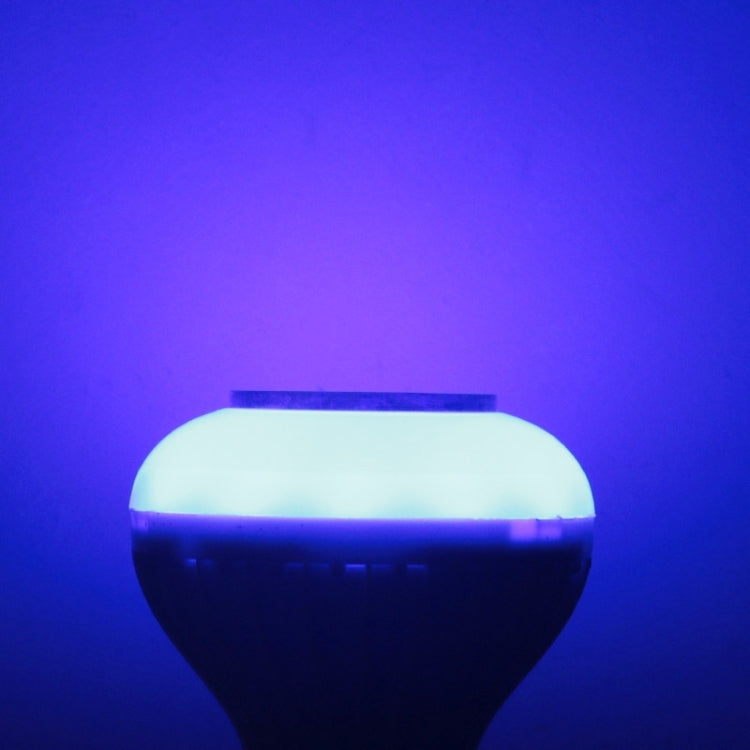 White smart LED bulb emitting blue light, round diffuser glow