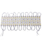 Warm white LED strip modules on a white backing with looped gray connector wires