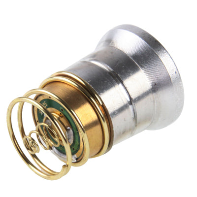 CREE flashlight LED drop-in module, side view of silver body with brass spring and contacts